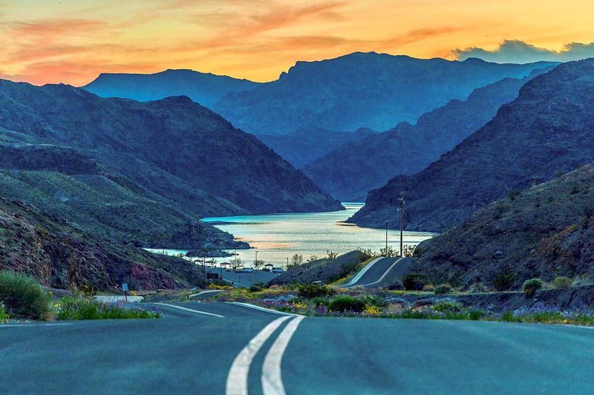 Empty desert highway stretching toward distant mountains