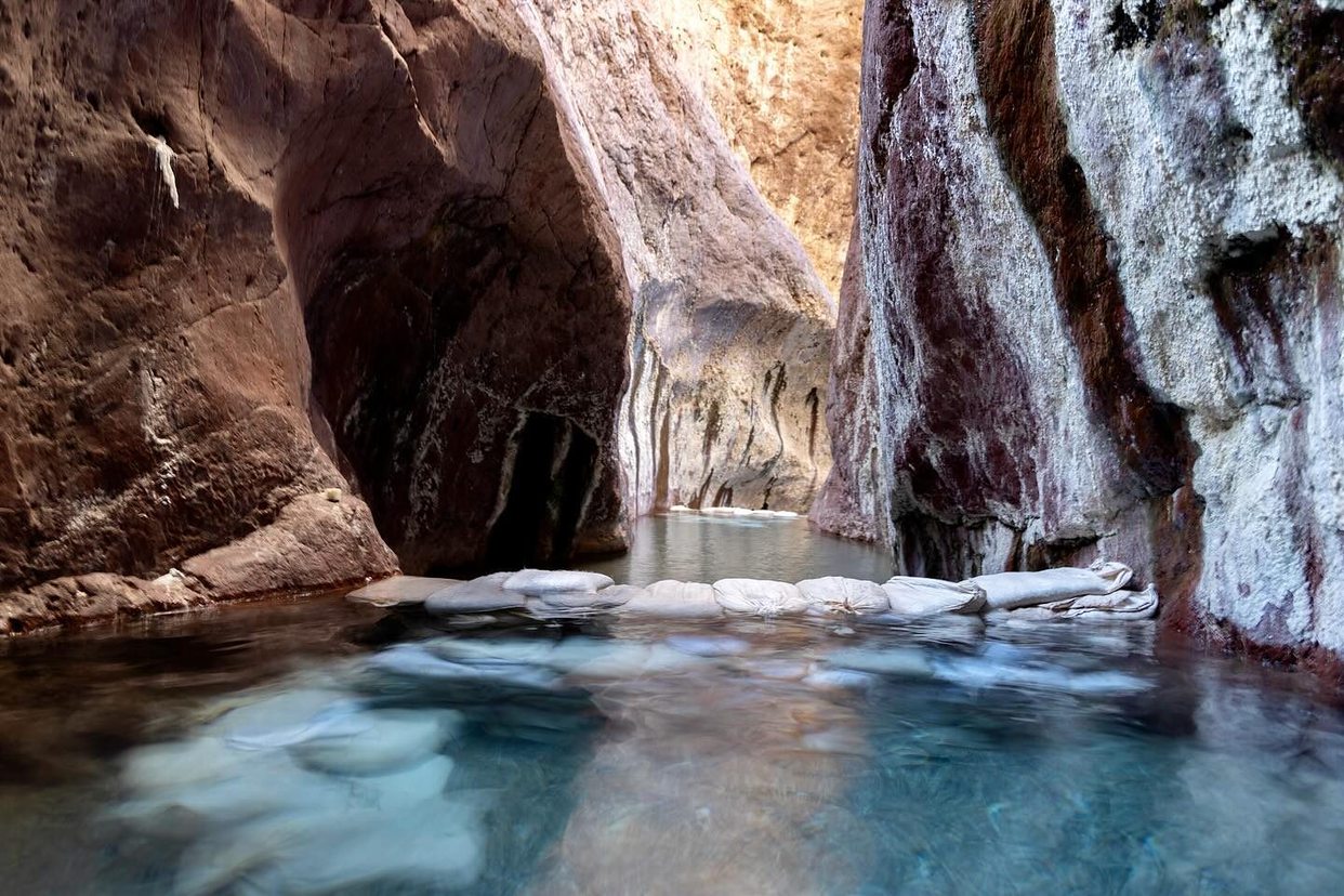Light filtering into a narrow sandstone slot canyon