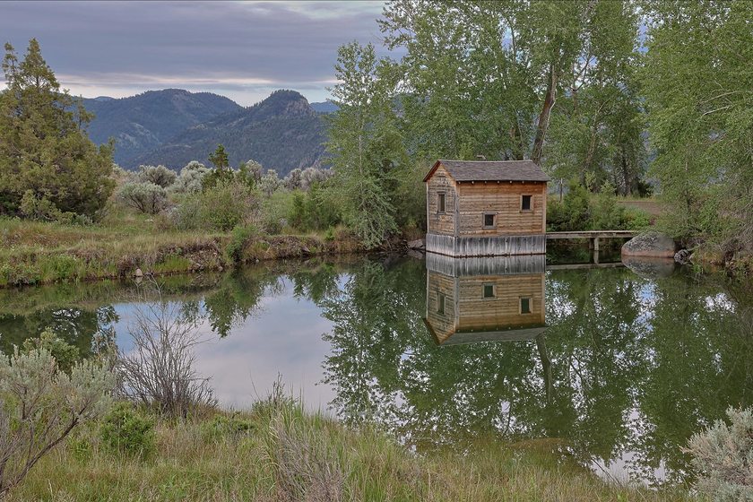Cabin reflected in still water