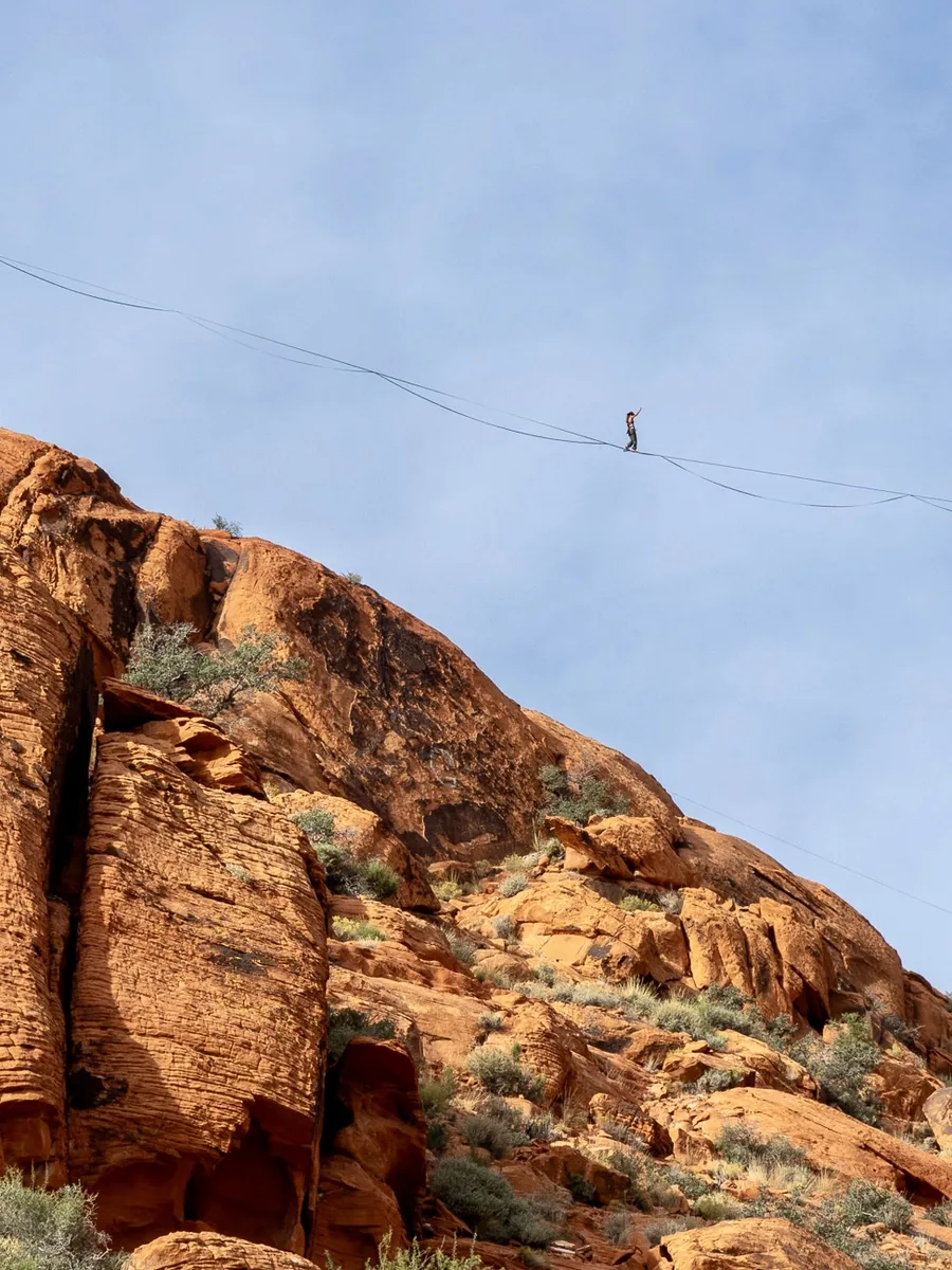 Highliner walking a line over red rock