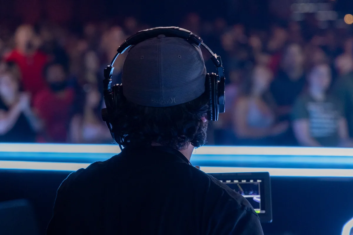 Sound engineer in headphones facing the crowd