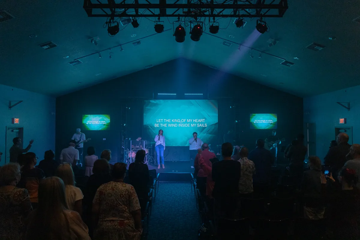 Church service lit in teal stage light