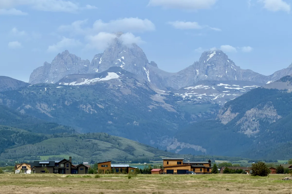 Snowy Teton peaks rising over homes in the valley